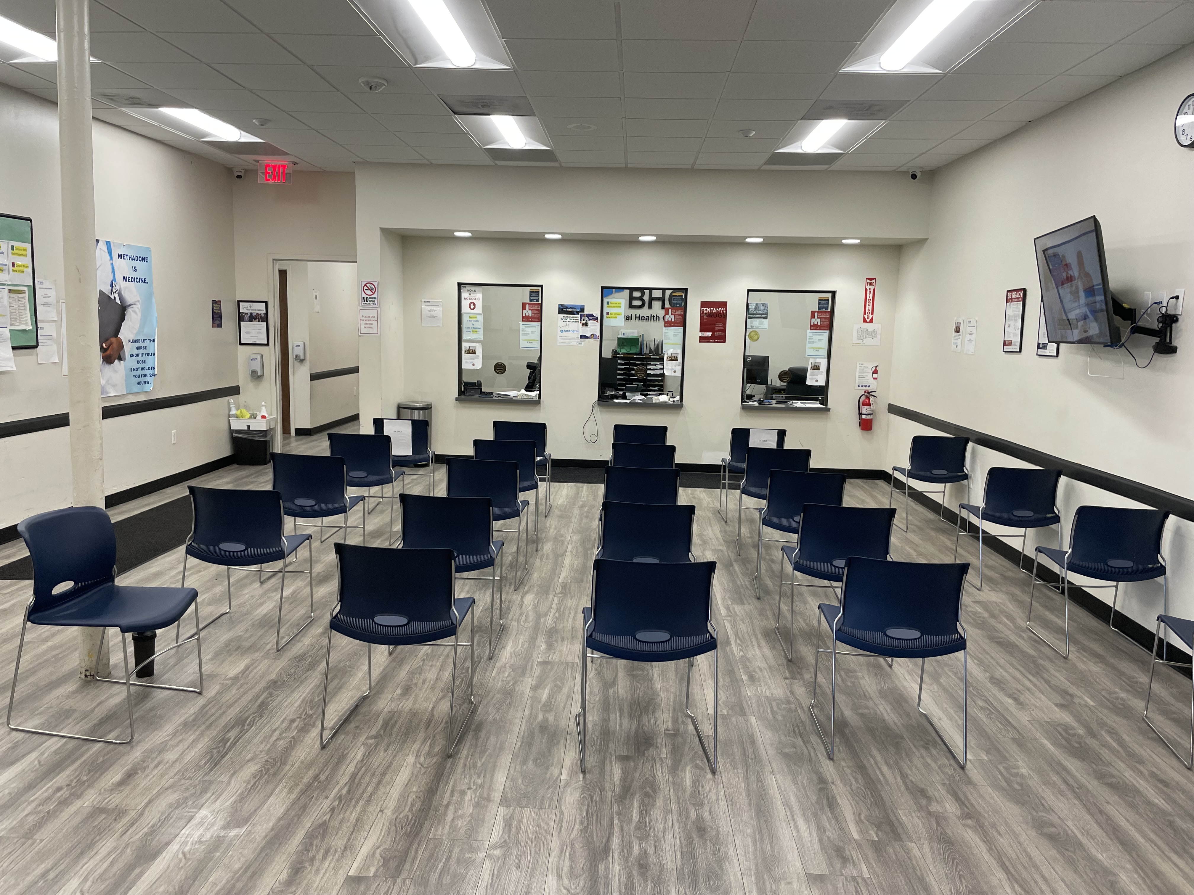 Spacious waiting room with seating and service windows