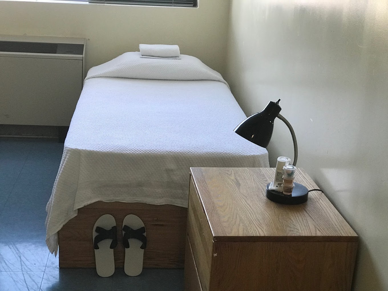 Single bed with white linen and a nightstand