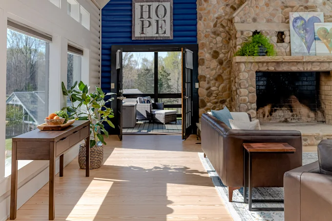 Lounge with leather sofas and stone fireplace