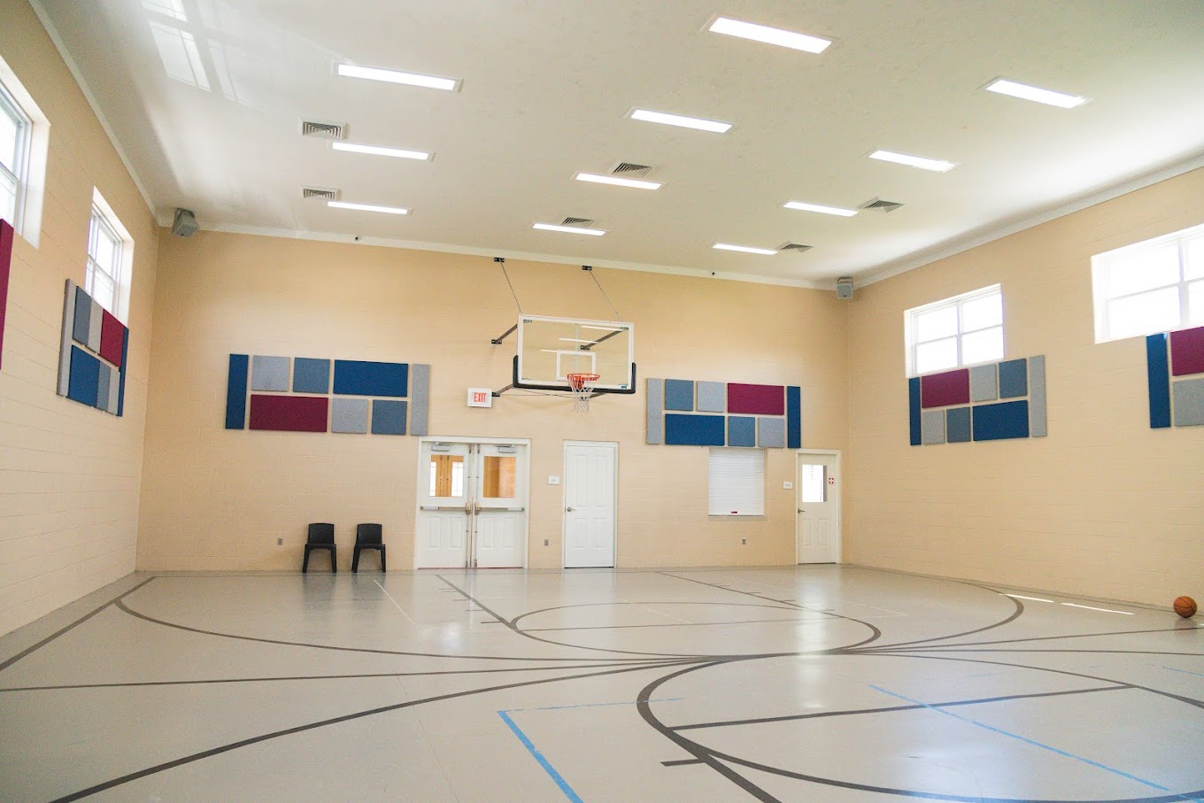 Spacious indoor basketball court with acoustic panels