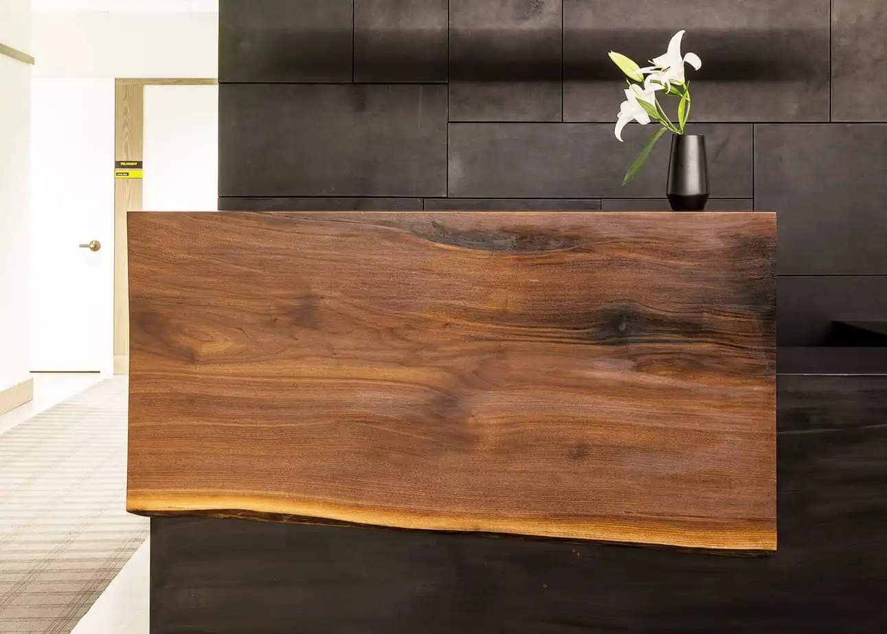 Wood reception desk with white lily in vase