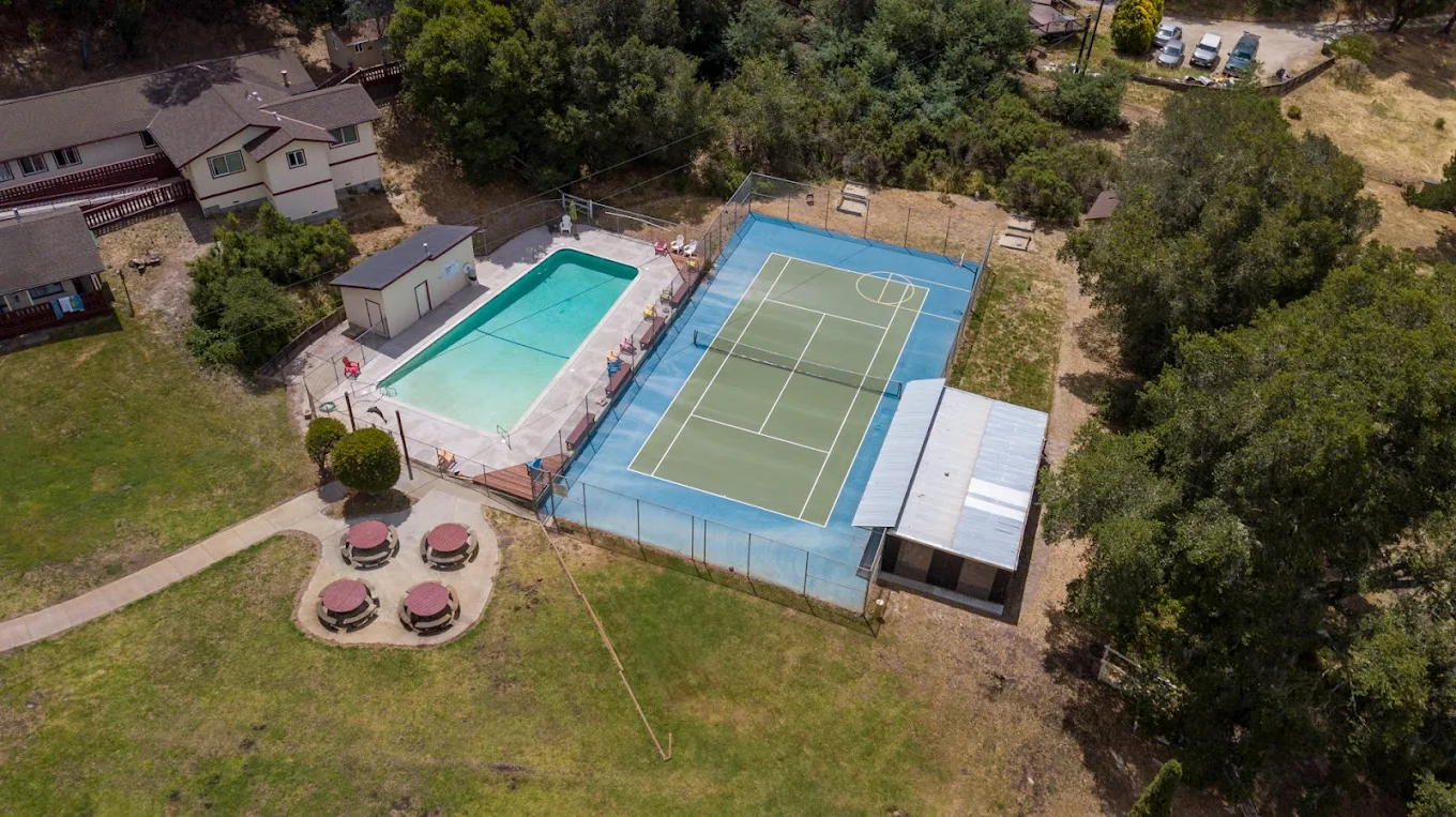 Outdoor swimming pool with lounge chairs nearby