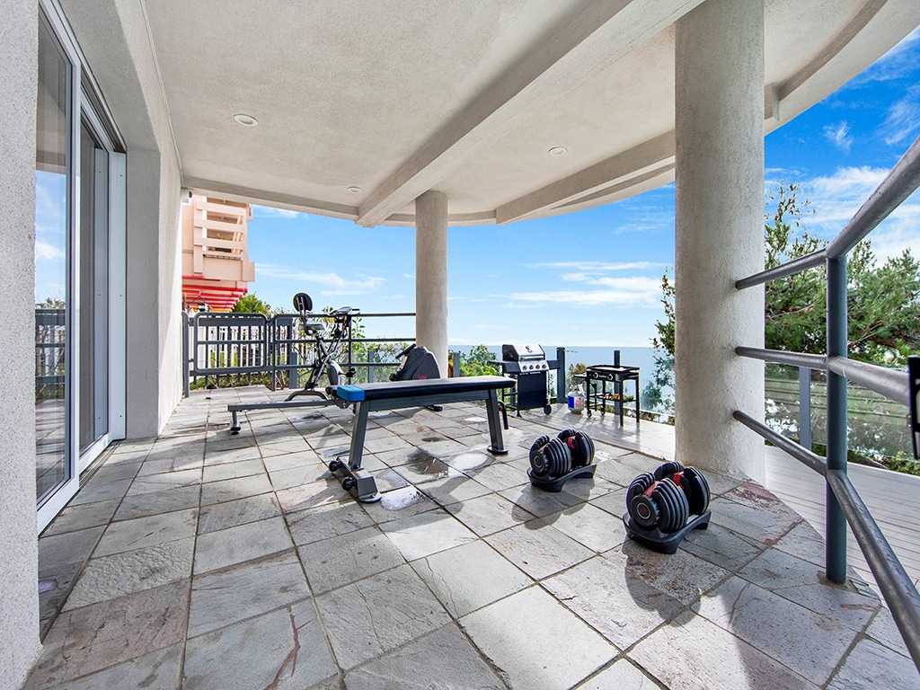 Exercise area with equipment and ocean view on patio
