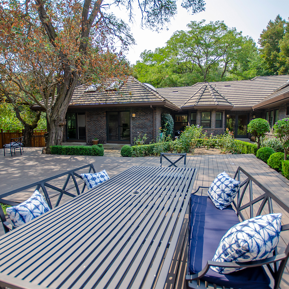 Outdoor patio with seating and a table.