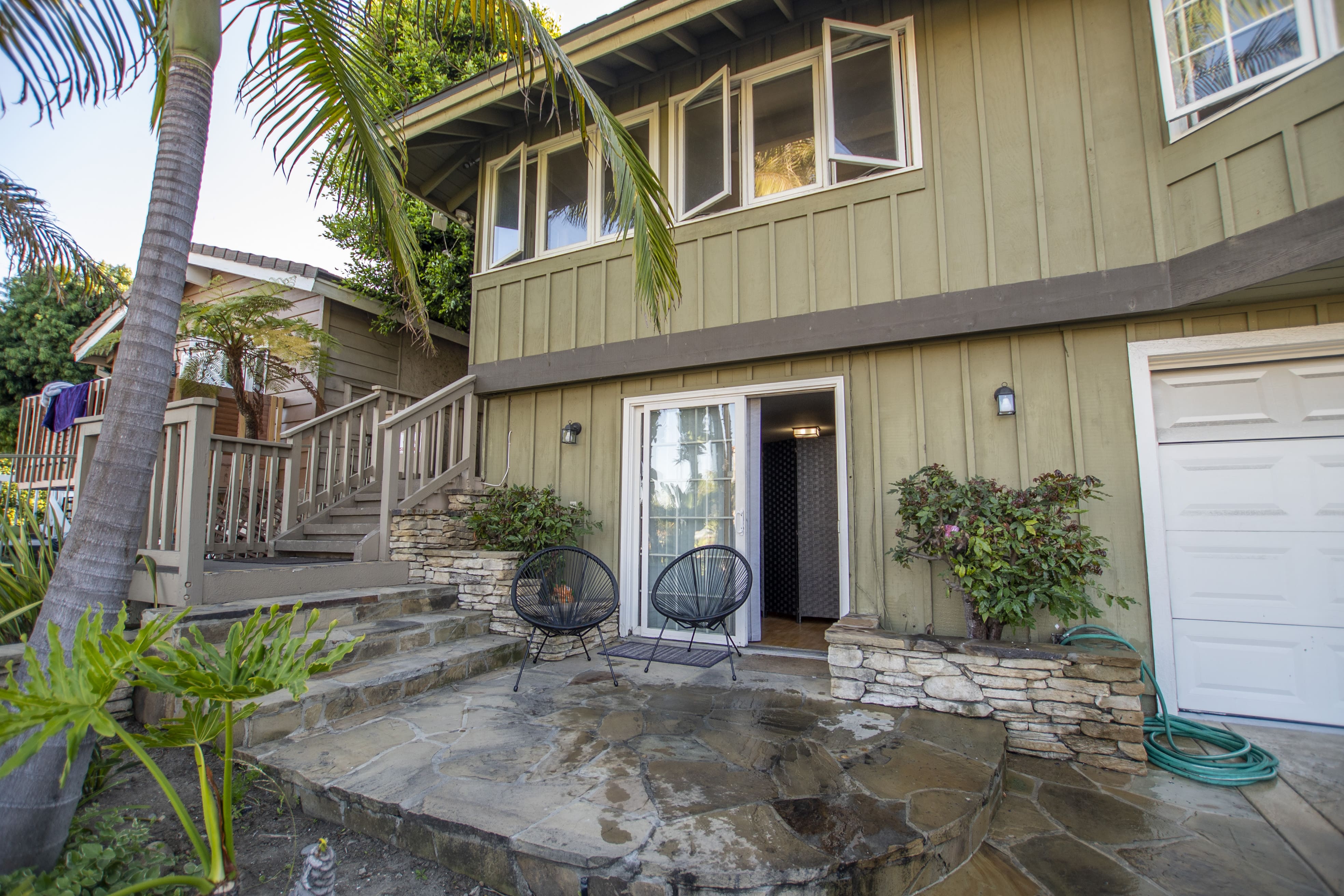 Patio and steps leading to two-story home