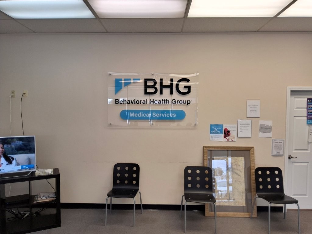 Lobby waiting area with seating and BHG wall sign