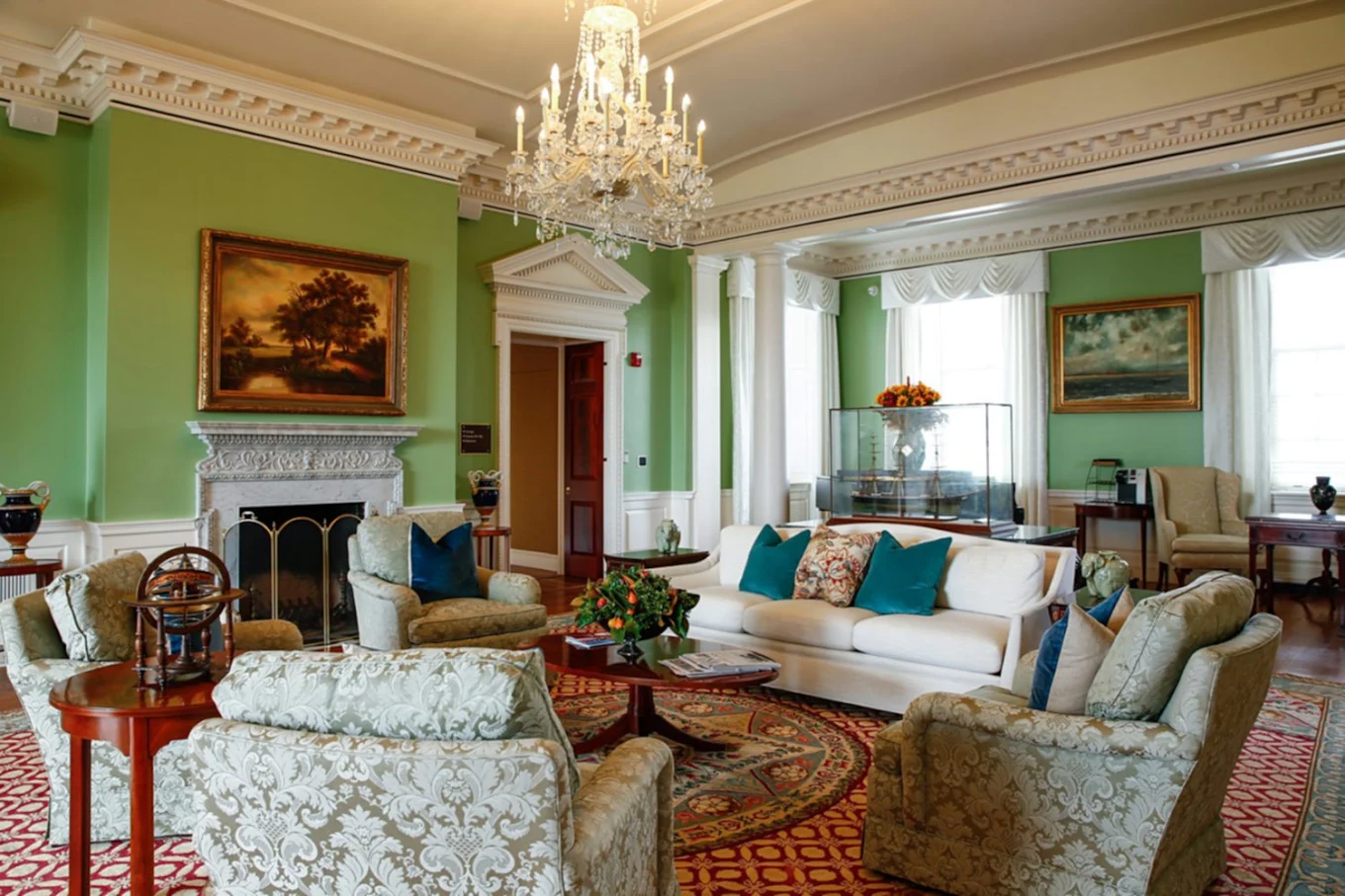 Elegant living room with sofas, fireplace, and chandelier