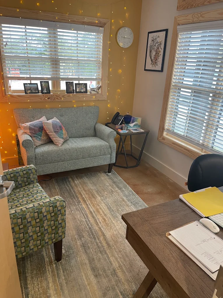 Small counseling office with sofa desk and decor
