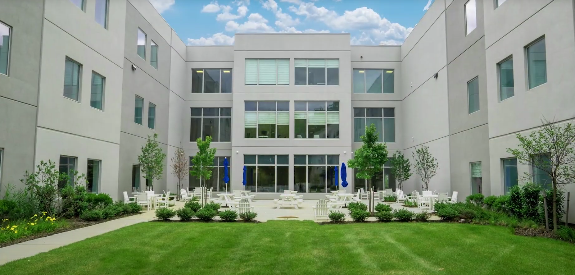 Outdoor courtyard with seating and landscaped green space