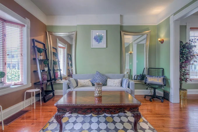 Sitting room with green walls and modern decor