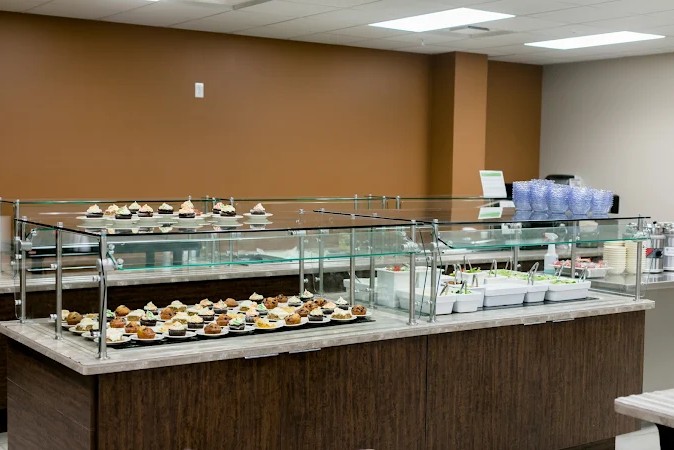 Buffet counter with desserts and food in dining area