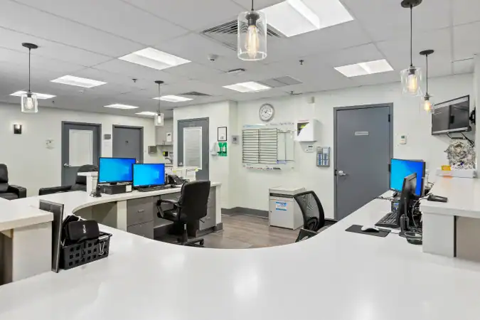 Clean nurses’ station with computers and curved front desk
