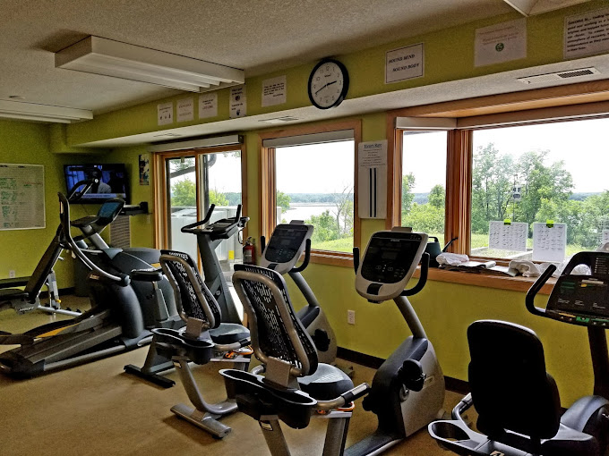 Workout area with treadmills and stationary bikes.