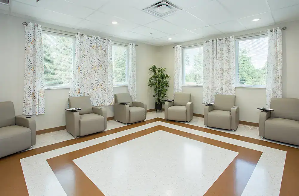 Circle of cushioned chairs in waiting lounge.