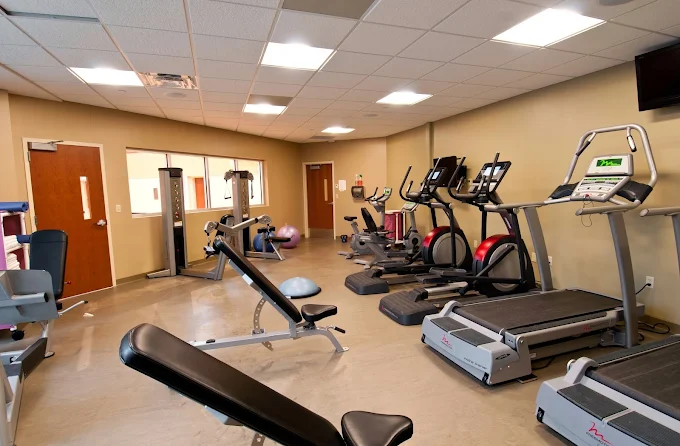 Fitness room with treadmills, weights, and workout machines