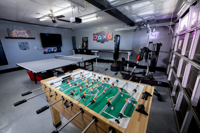 Recreation room with foosball, ping pong, and gym equipment