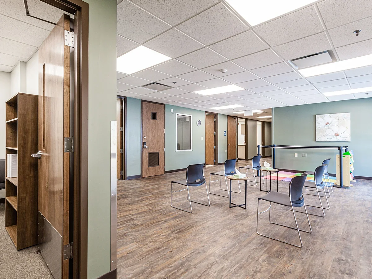 Open room with spaced chairs arranged for group therapy sessions