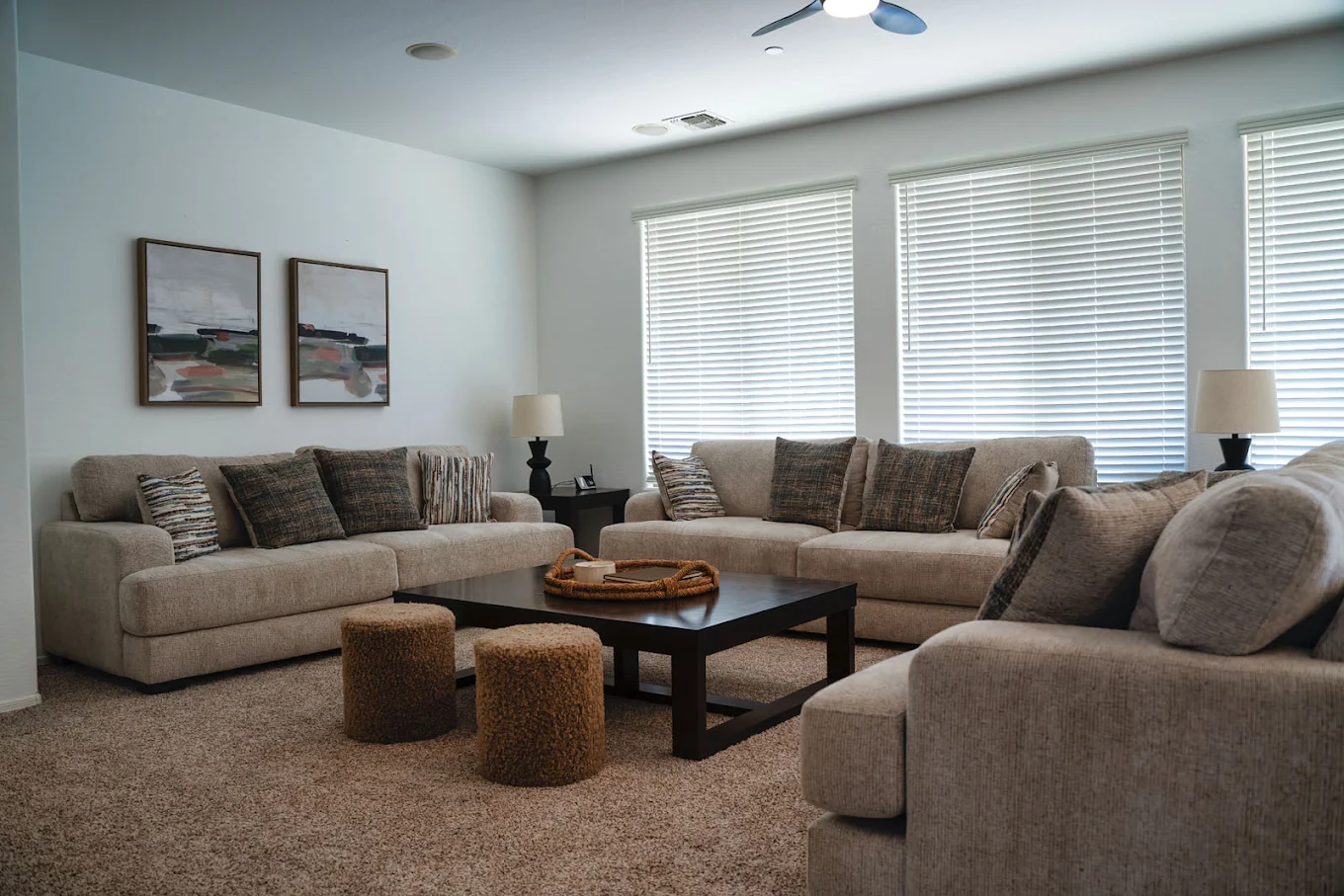 Cozy living room with sofas, coffee table, and soft lighting