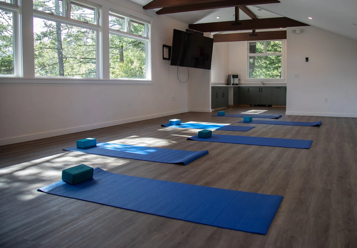 Yoga room with mats and natural light from large windows