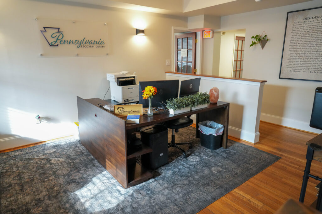 Front desk with signage and computer setup