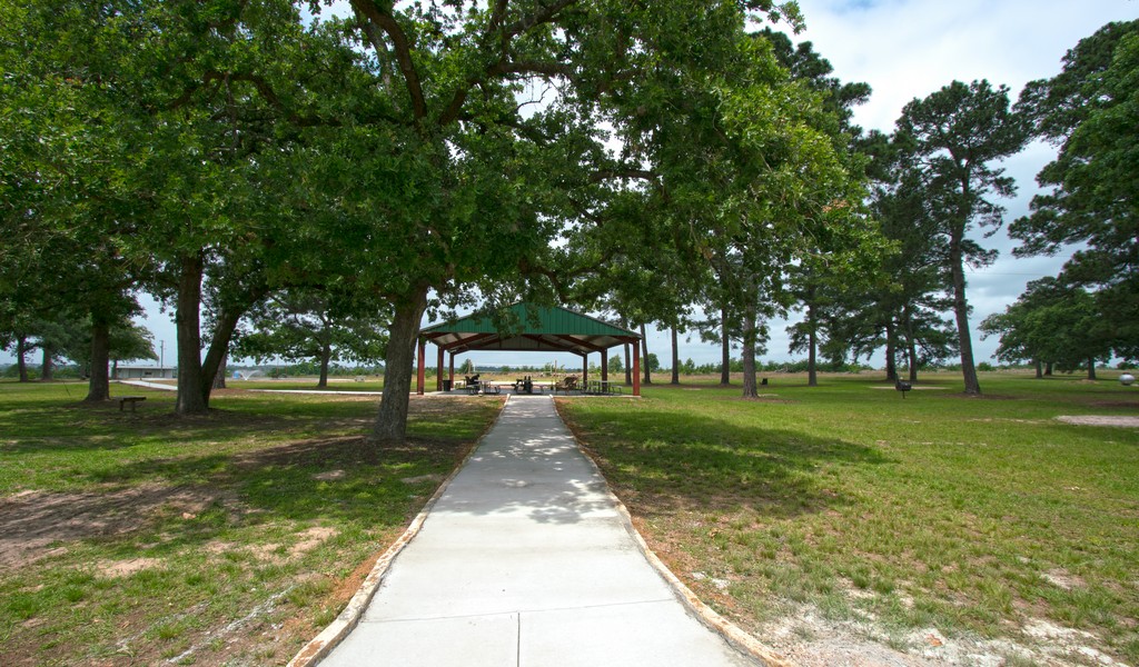 Outdoor pathway leading to a shaded pavilion.