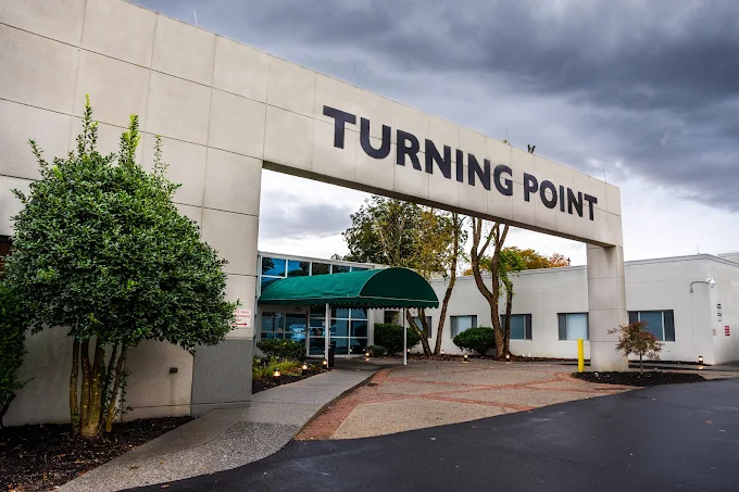 Building entrance with Turning Point sign and green canopy