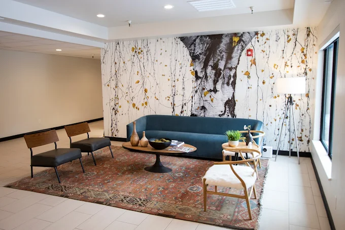 Modern lobby with backlit reception desk and floral décor