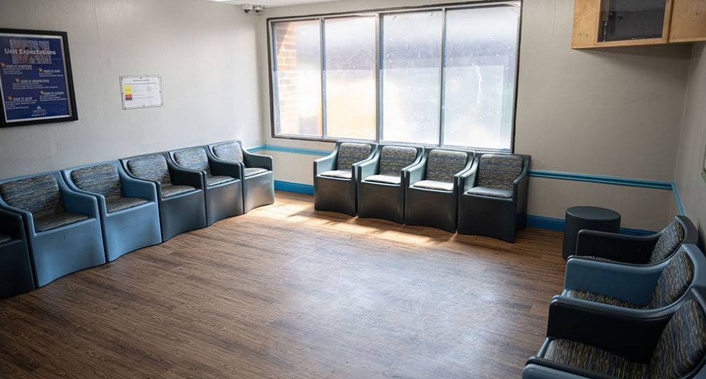 Patient lounge with chairs and natural light