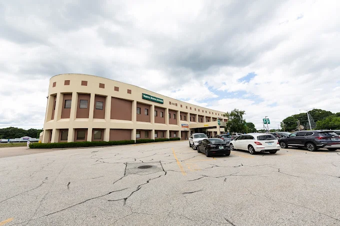 Facility exterior with parking lot and cars outside