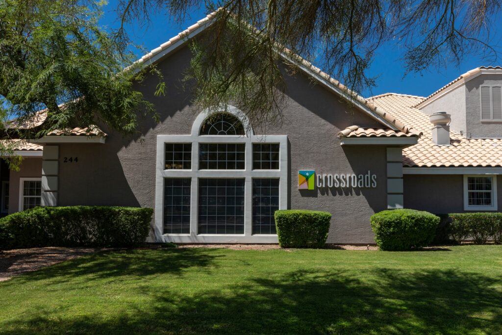 Crossroads facility exterior with manicured lawn and sign