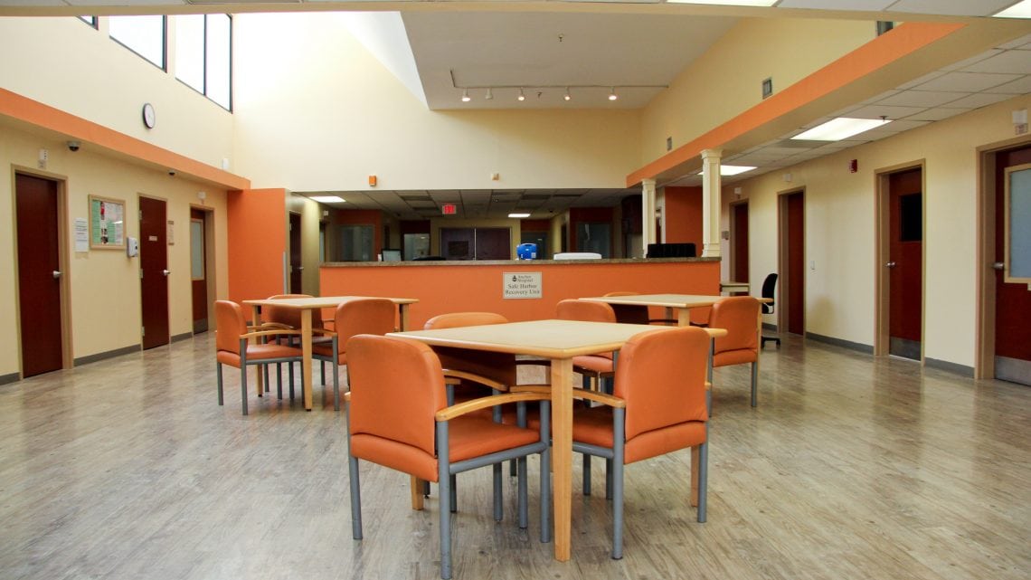 Warm-toned waiting area with reception desk and seating