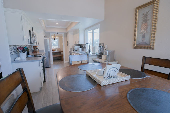 View of open kitchen leading into dining and living areas