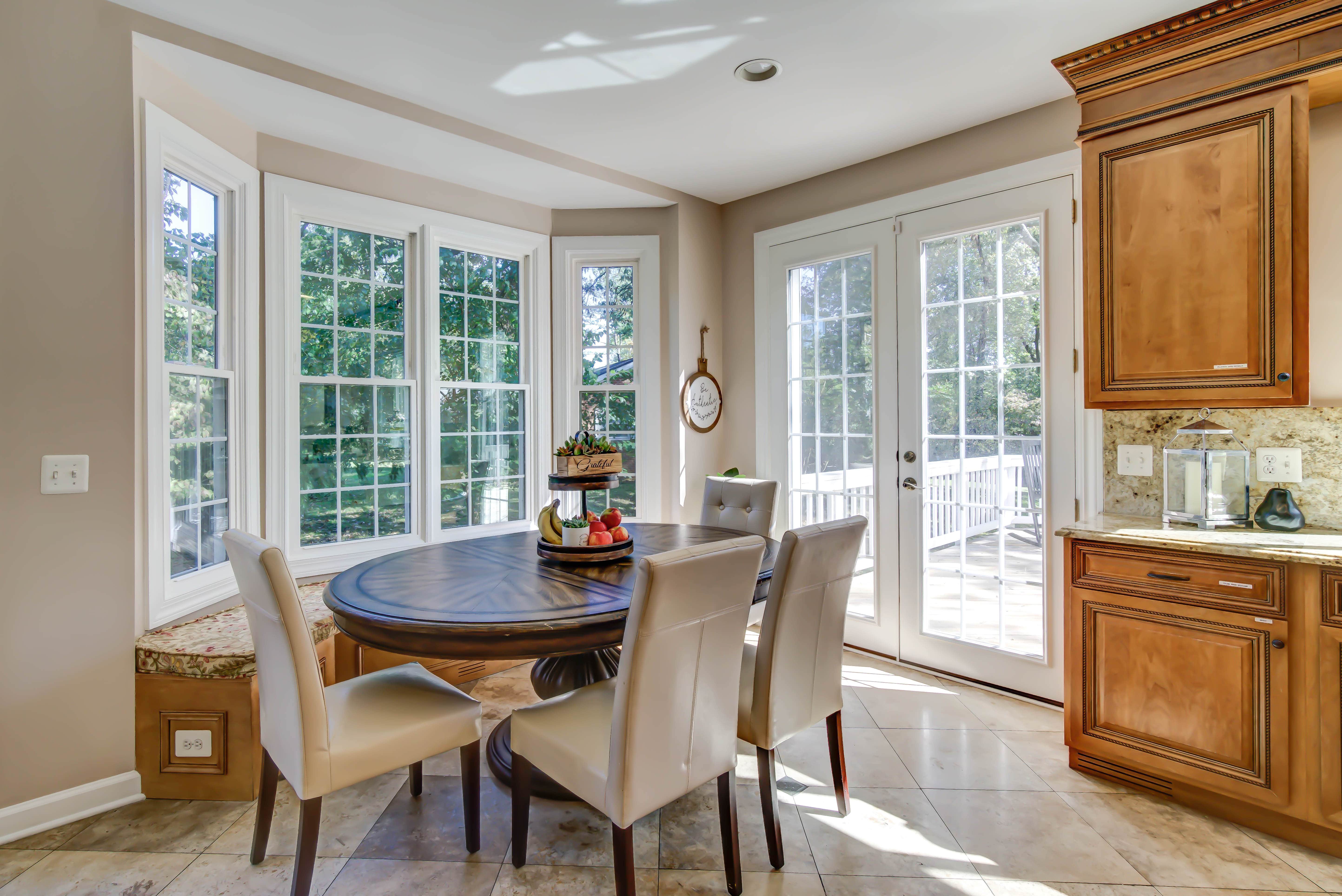 Sunny breakfast nook with round table and bay window