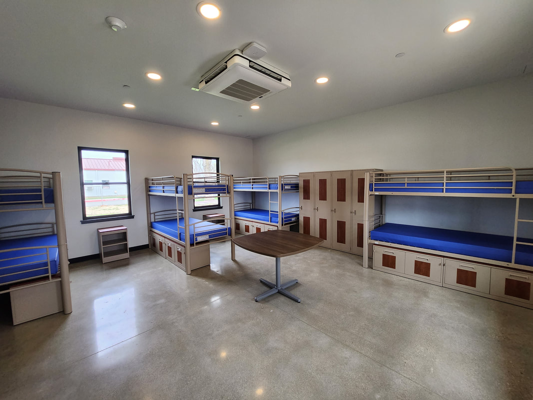 Dorm-style client room with bunk beds and lockers