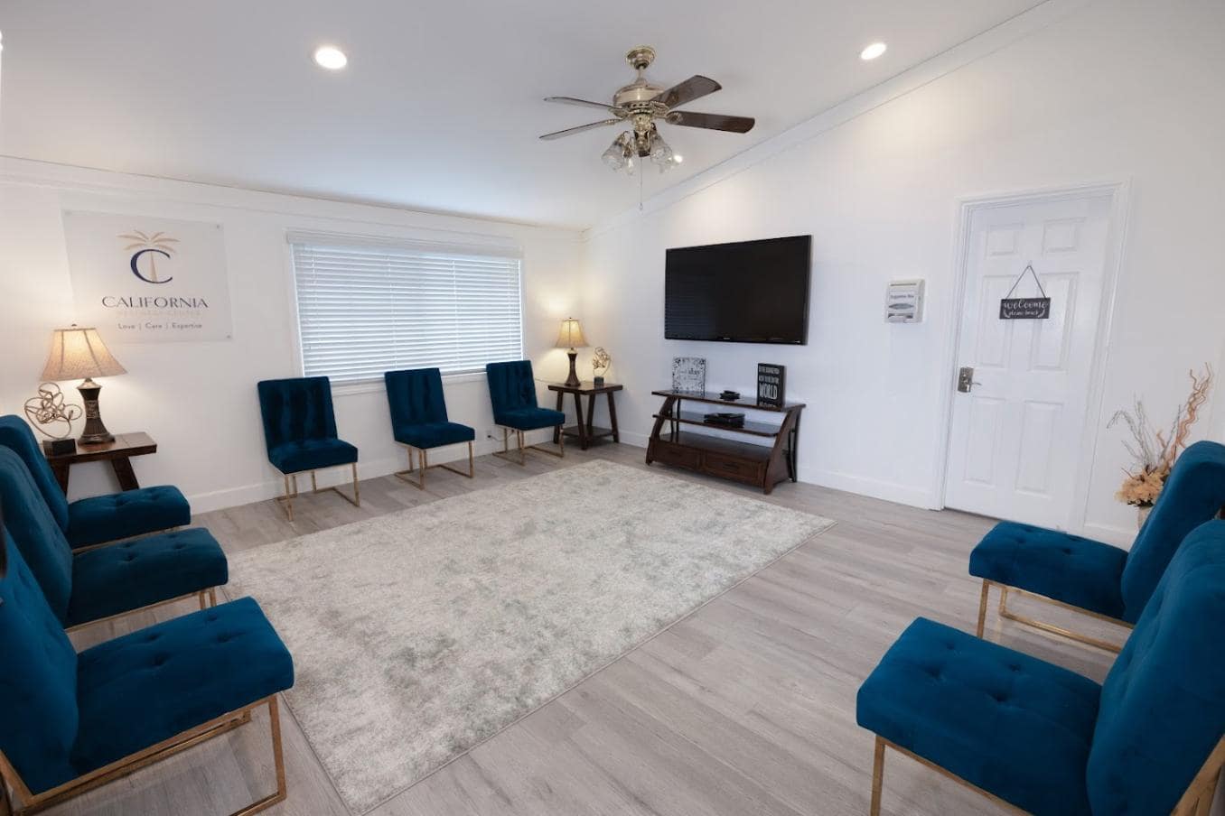 Spacious room with blue chairs arranged for group meetings