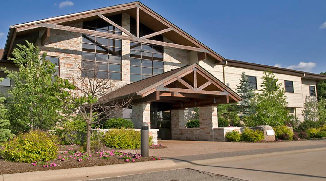 Facility exterior with entrance and landscaped grounds