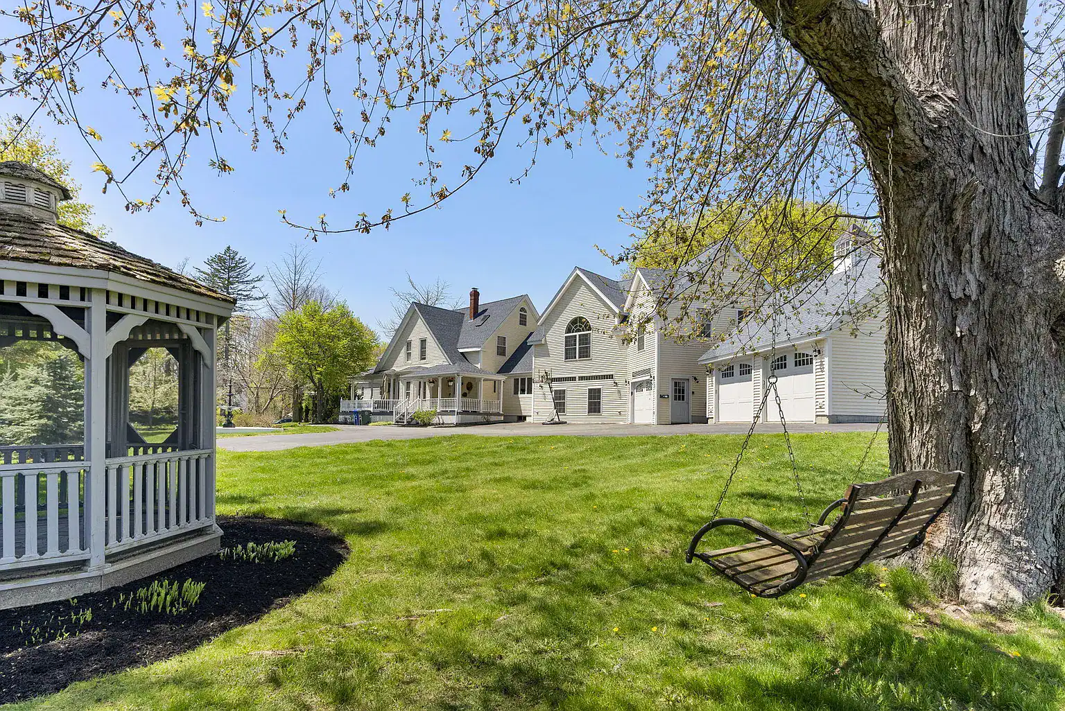 Gazebo, tree swing, and landscaped grounds overlooking the Southern Maine Recovery residential campus