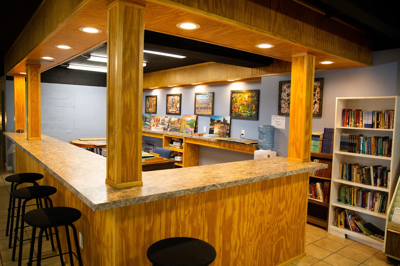 Wooden counter space with bookshelves and framed art