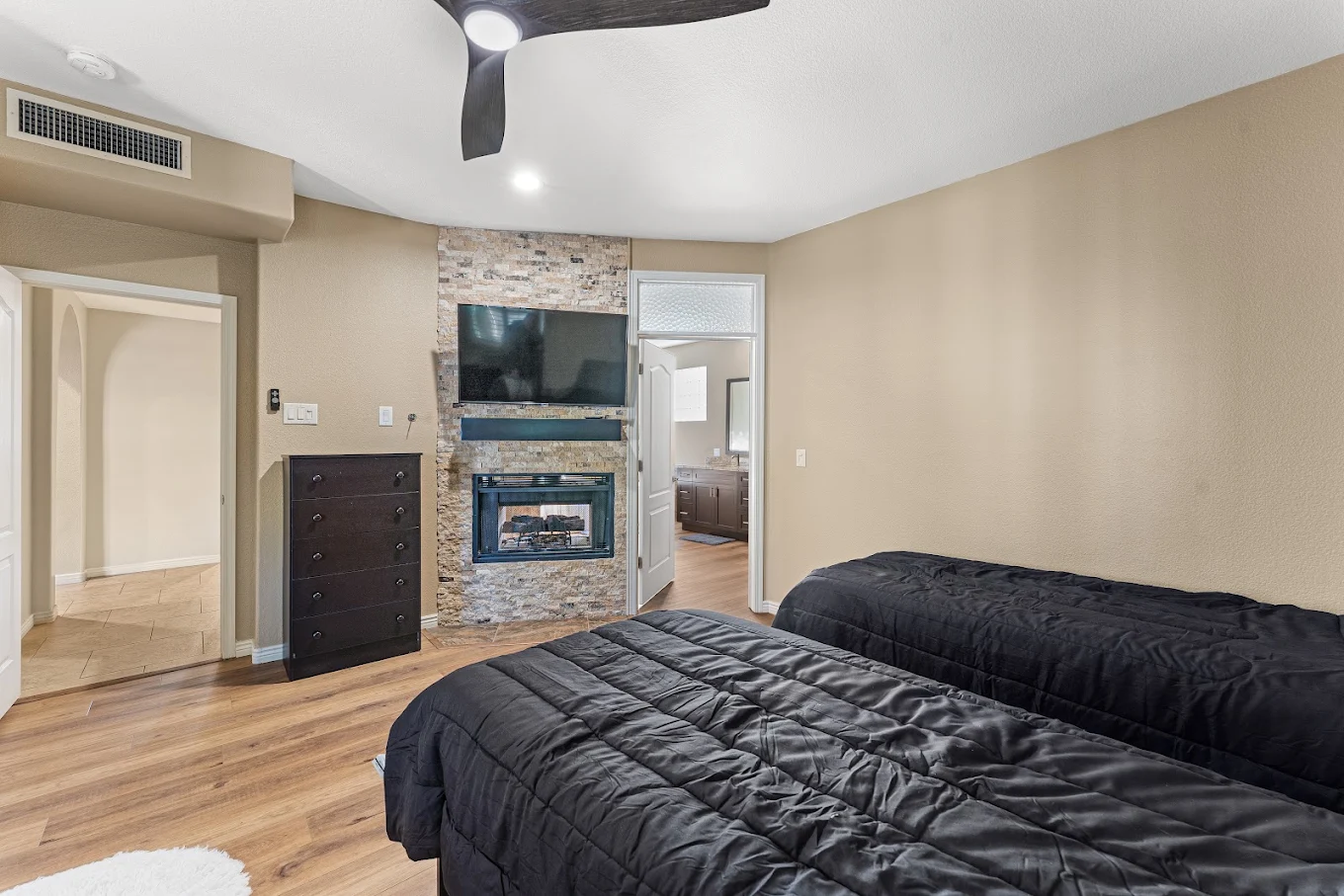 Shared bedroom with two beds, fireplace, and TV