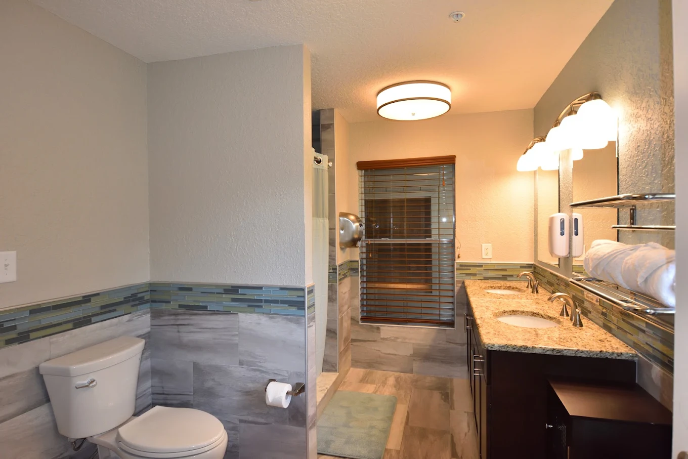 Modern bathroom with granite sink and shower
