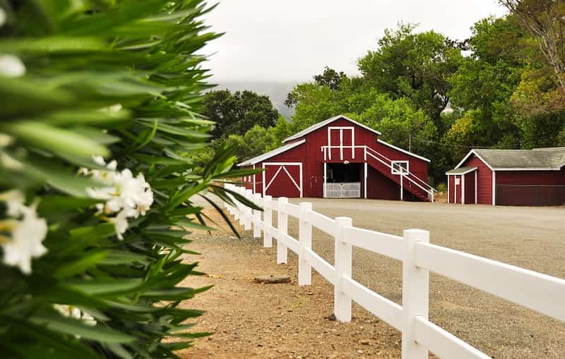 Red barn with white fencing on the treatment campus