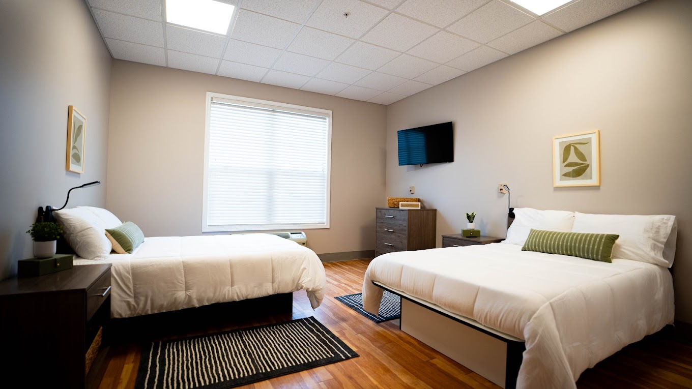 Double bedroom with white bedding and modern decor.