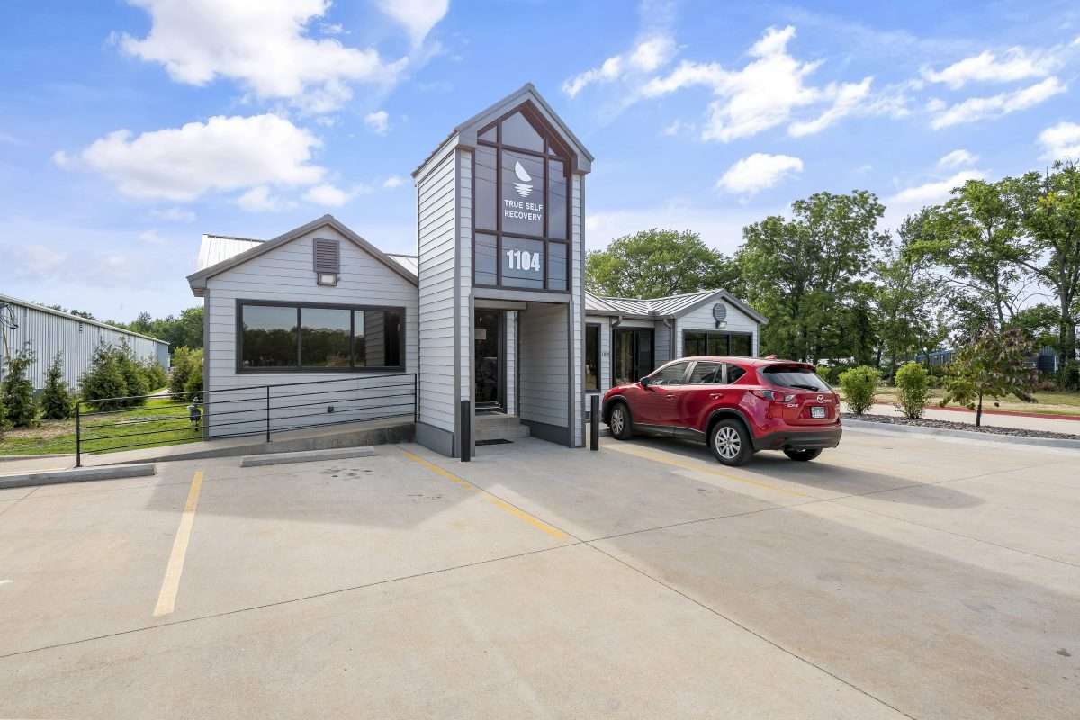 Exterior of True Self Recovery with front parking and red SUV