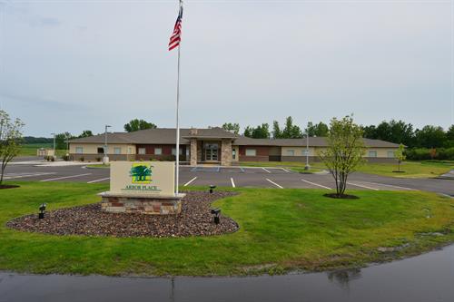 Front entrance of facility with flag and driveway