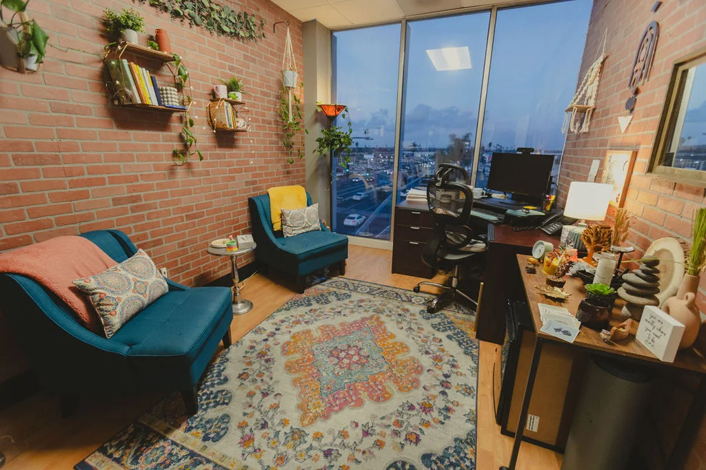 Cozy office with desk, seating, rug, and brick accent wall