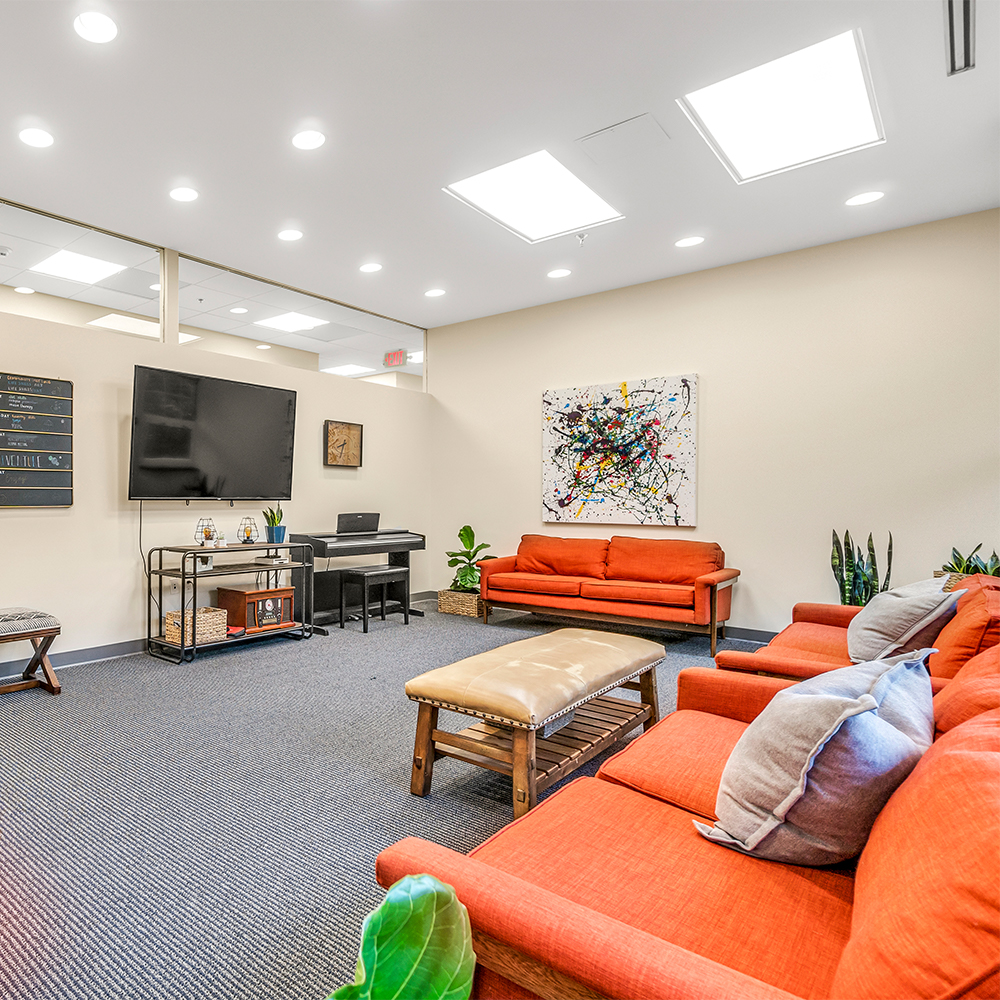 Lounge area with  sofas and a piano.