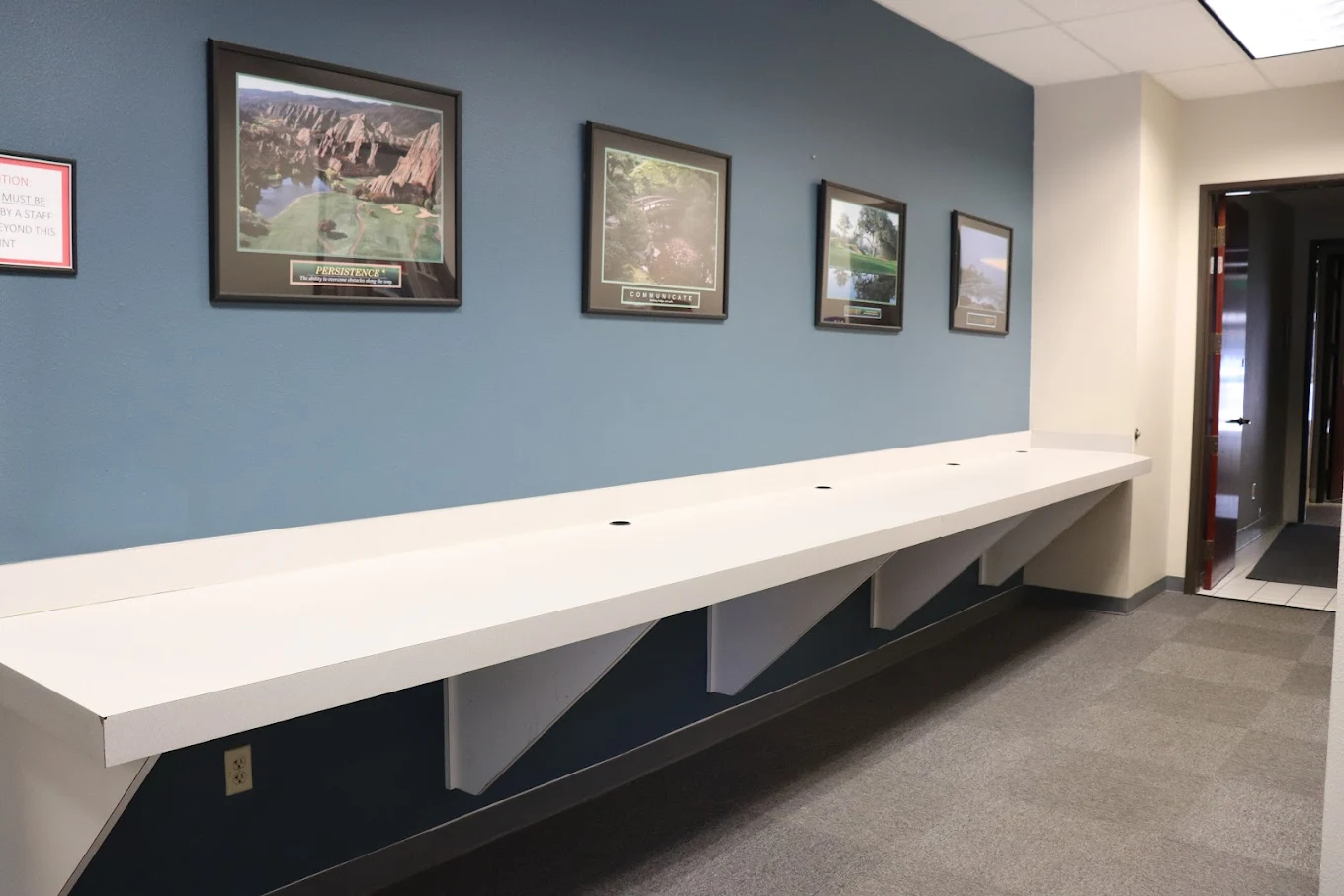 Long counter workspace along wall with framed artwork