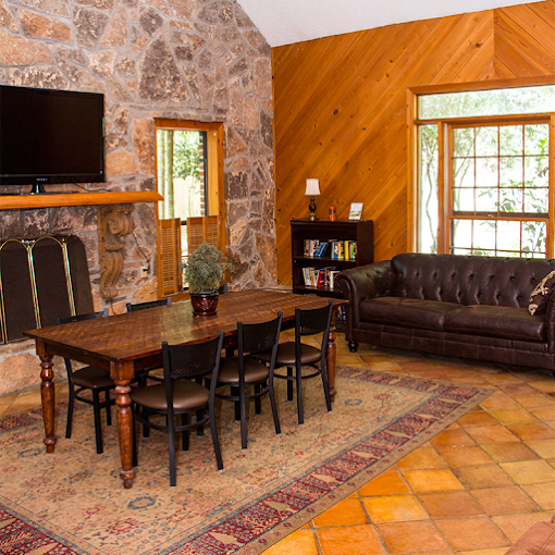 Dining area with stone fireplace and leather sofa