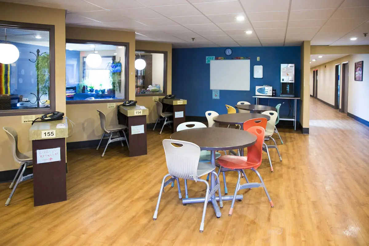 Common area with tables, chairs, and resident phone stations