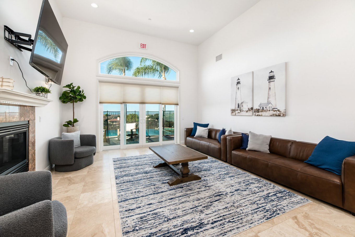 Spacious lounge with sofas, TV, fireplace and large windows.